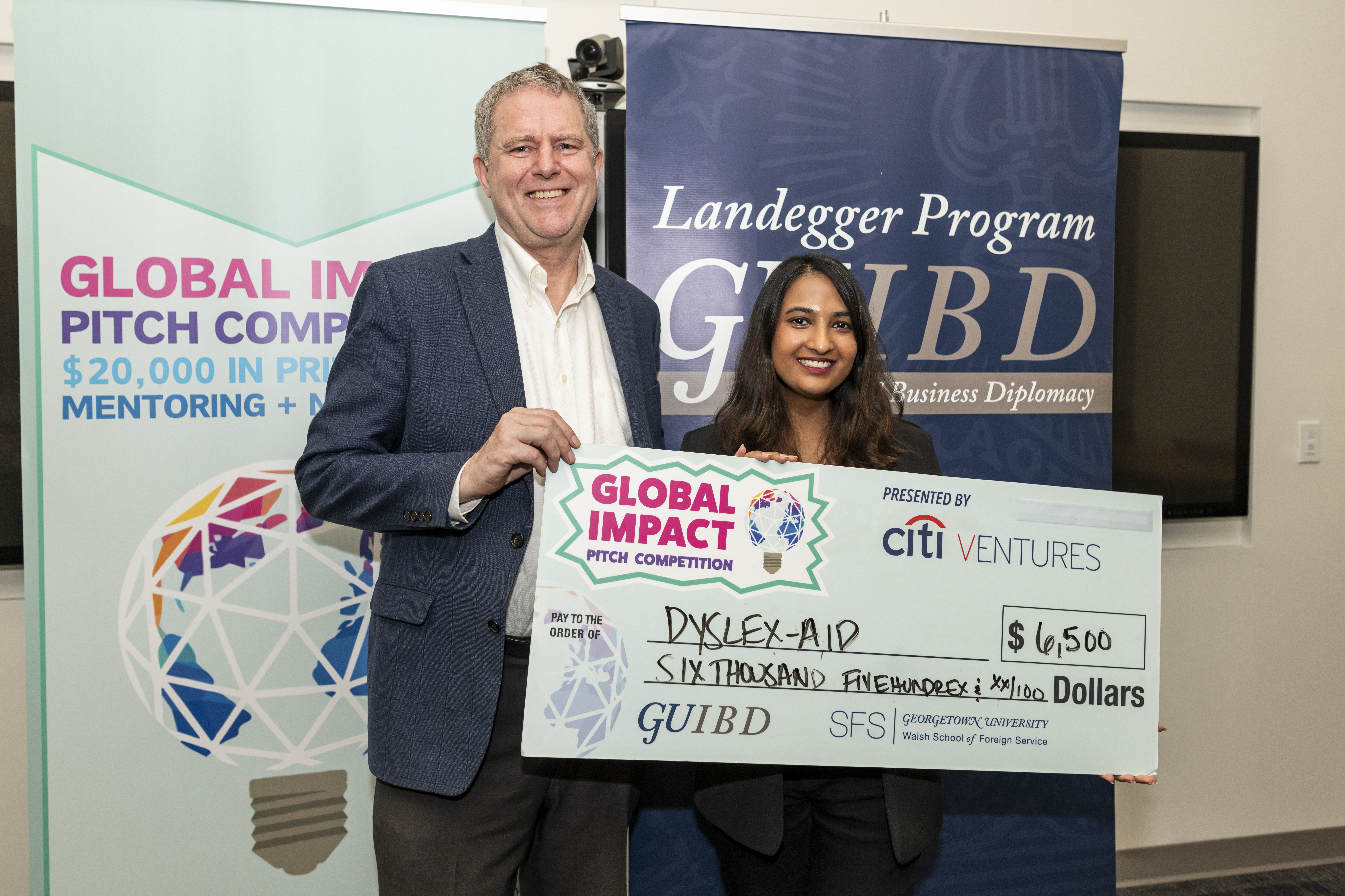 Riya Mittal holding the $6,500 Dyslex-Aid pitch competition cheque